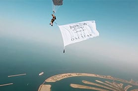 SKYDIVE DUBAI FLAG BANNER ADVERTISING UNDER PARACHUTE